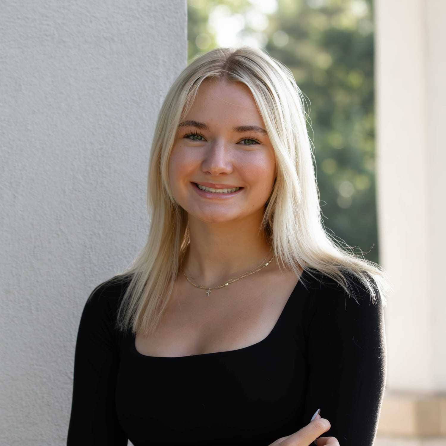 Portrait of Emma V., a professional stylist at First Impressions Salon & Spa, showcasing their expertise and style.