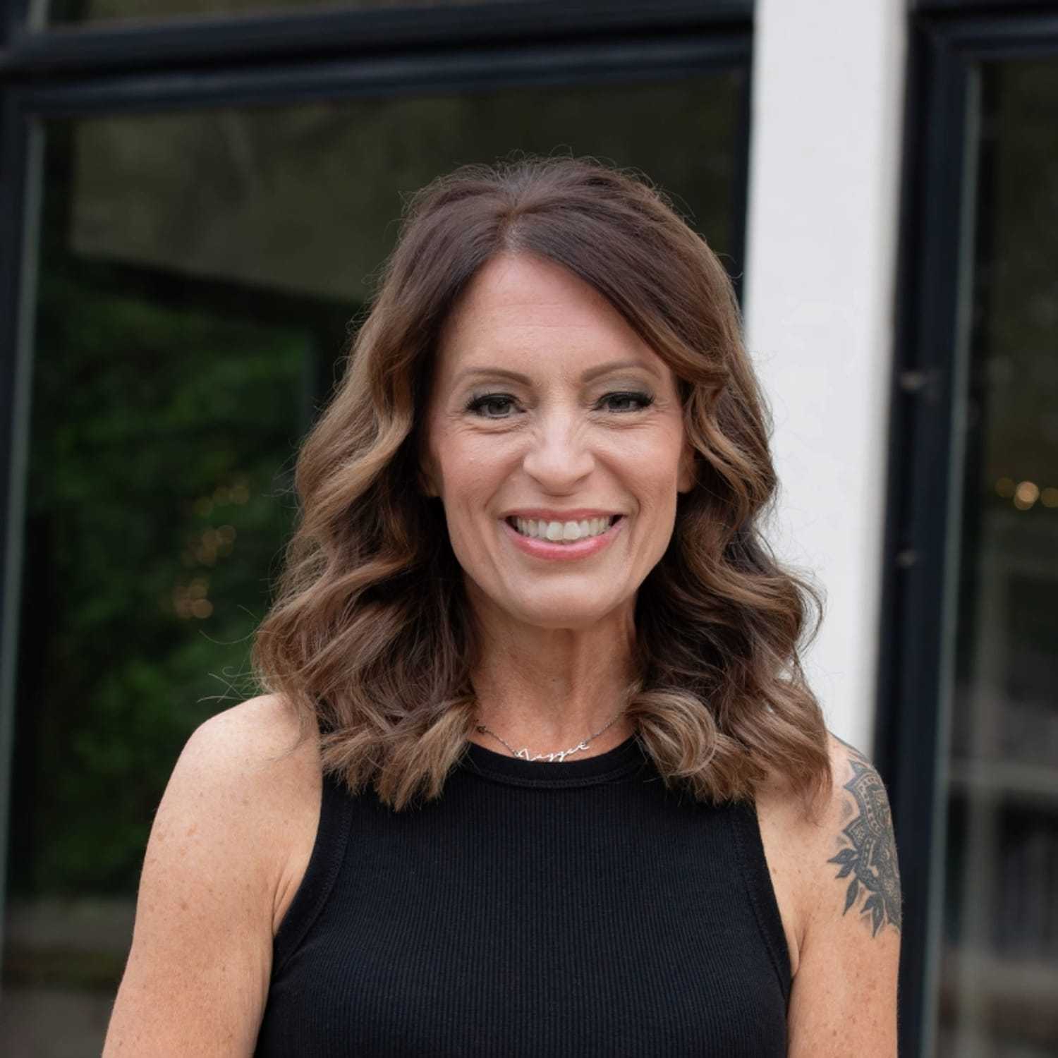 Portrait of Megan W., a professional stylist at First Impressions Salon & Spa, showcasing their expertise and style.