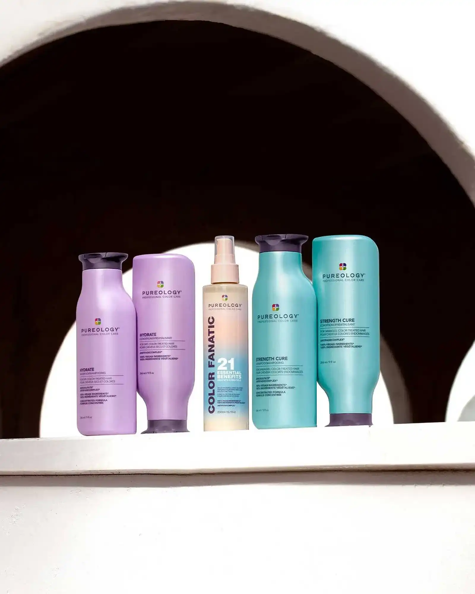 Pureology haircare products displayed on an arched ledge.