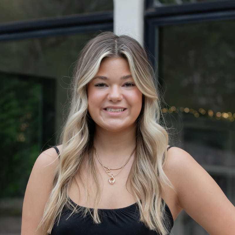 Portrait of Sam K., a professional stylist at First Impressions Salon & Spa, showcasing their expertise and style.