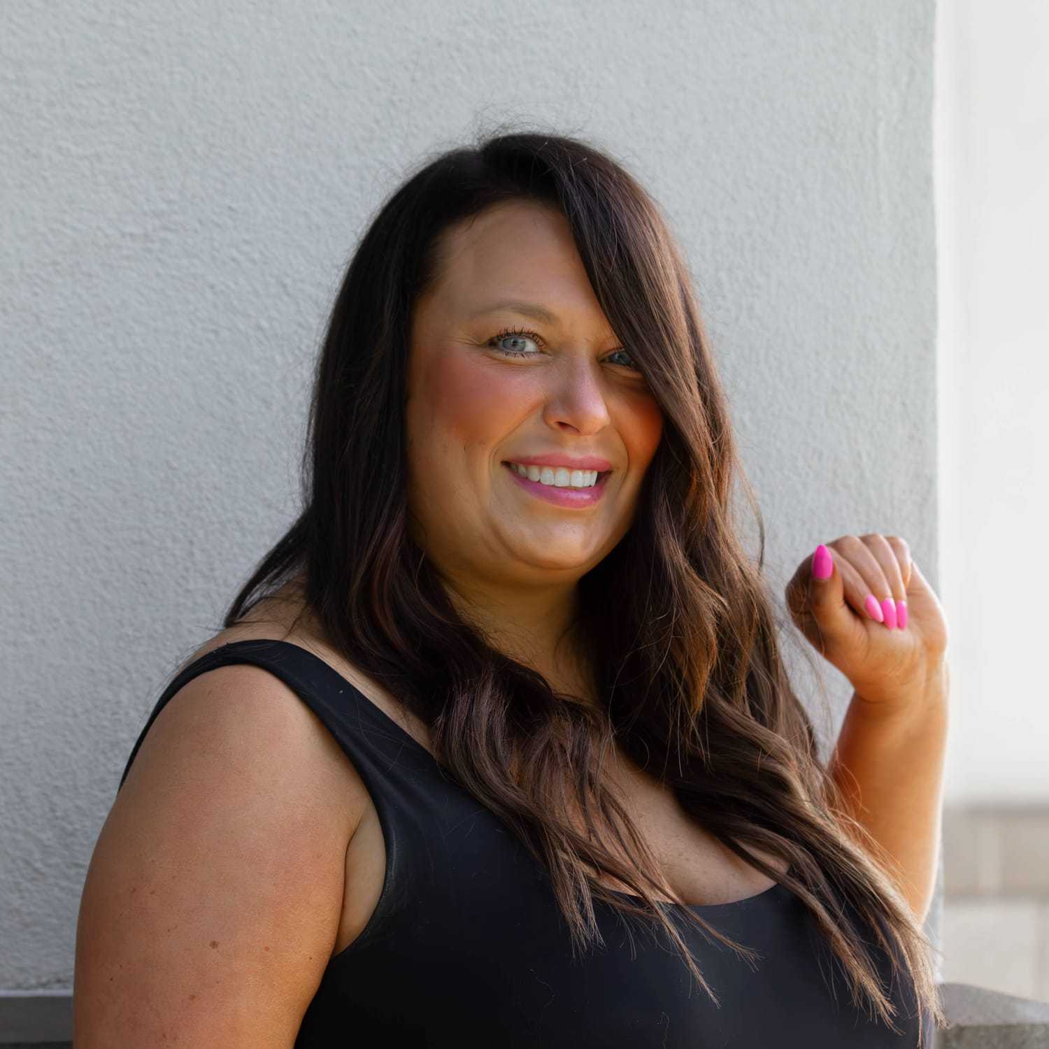 Portrait of Ashley B., a professional stylist at First Impressions Salon & Spa, showcasing their expertise and style.