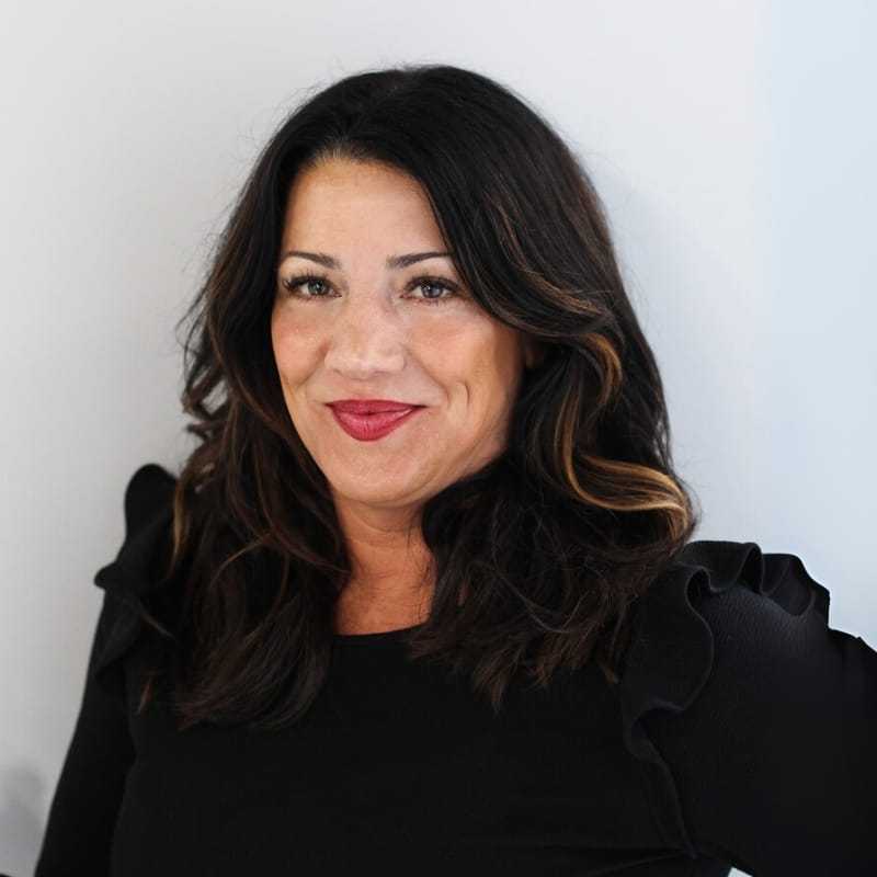 Portrait of Leigh P., a professional stylist at First Impressions Salon & Spa, showcasing their expertise and style.