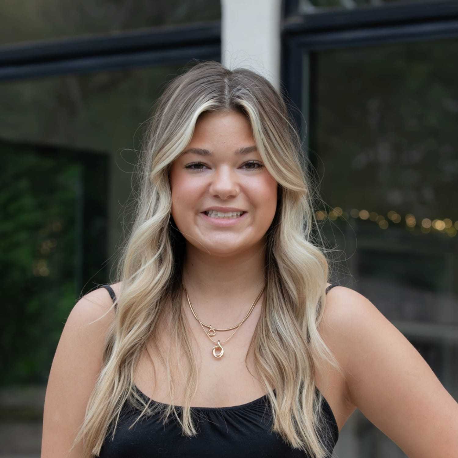 Portrait of Sam K., a professional stylist at First Impressions Salon & Spa, showcasing their expertise and style.