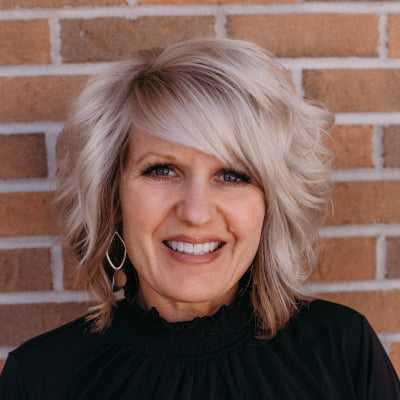 Portrait of Gretchen L., a professional stylist at First Impressions Salon & Spa, showcasing their expertise and style.