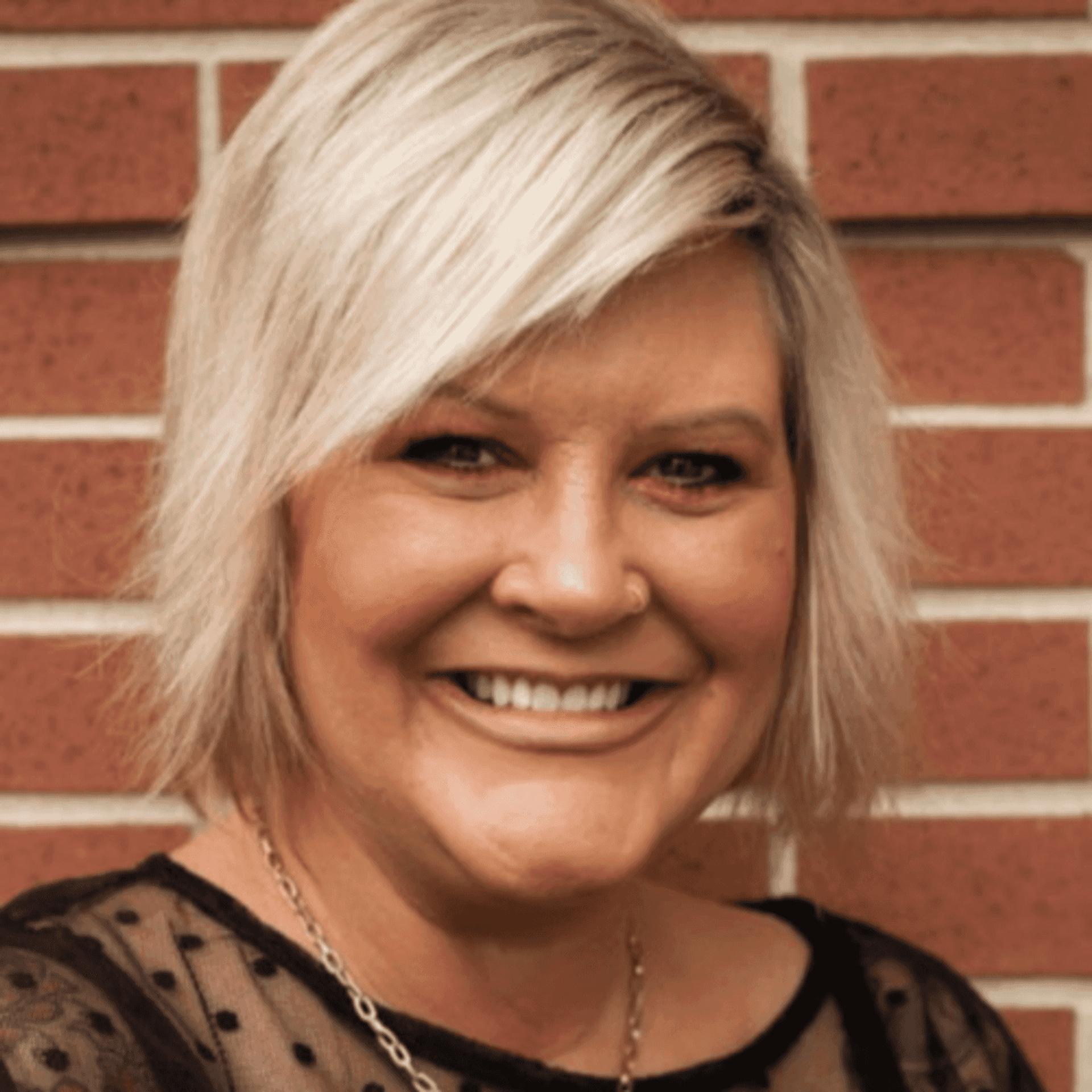 Portrait of Amy O., a professional stylist at First Impressions Salon & Spa, showcasing their expertise and style.