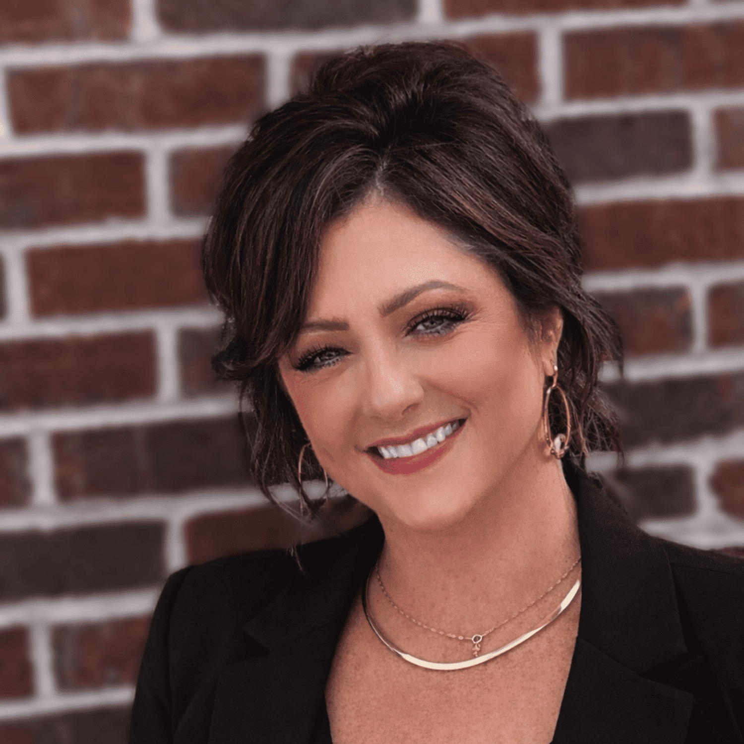 Portrait of Trudy M., a professional stylist at First Impressions Salon & Spa, showcasing their expertise and style.