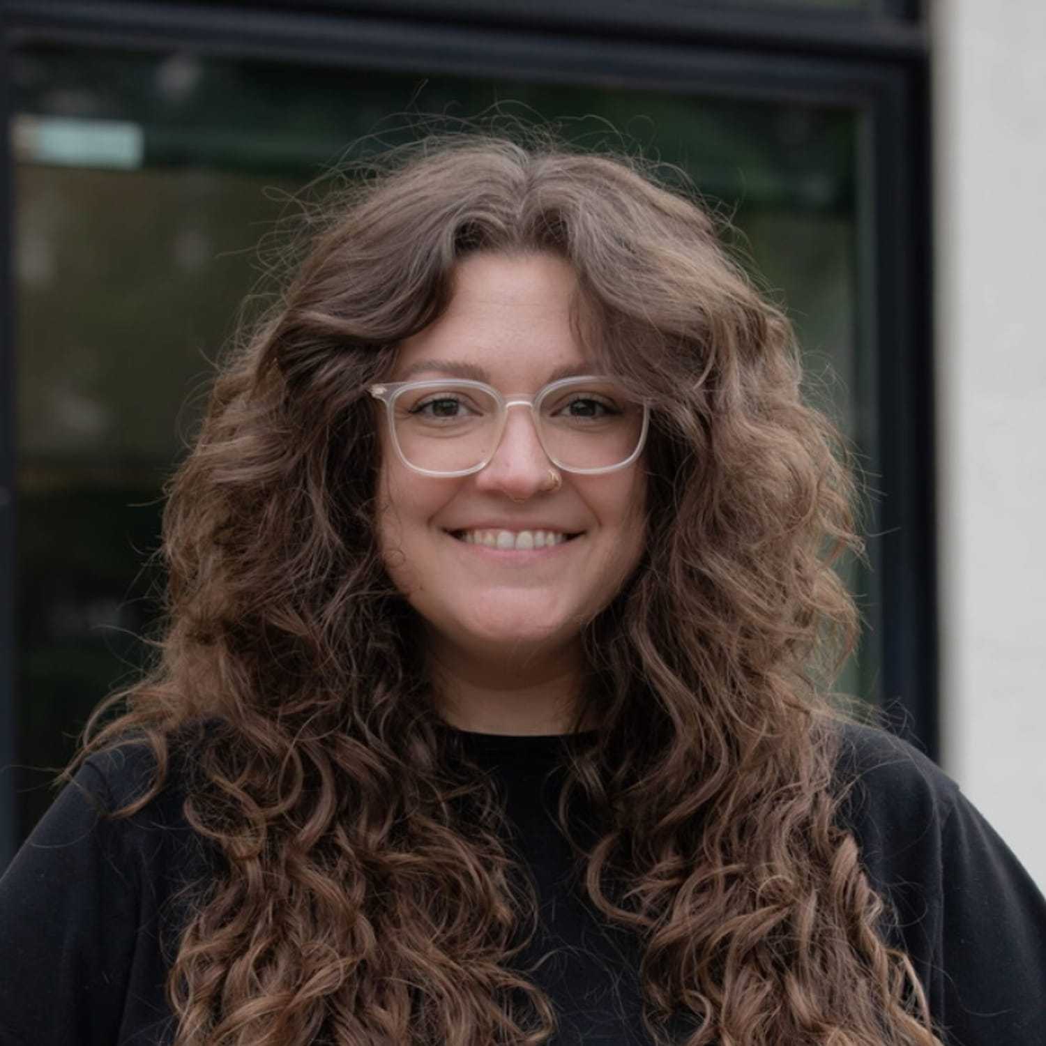 Portrait of Hannah C., a professional stylist at First Impressions Salon & Spa, showcasing their expertise and style.