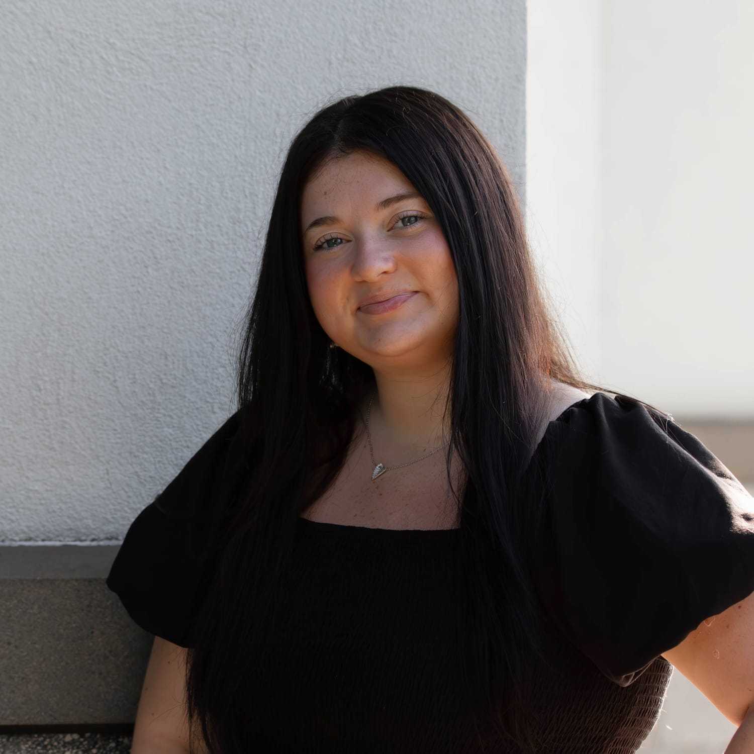 Portrait of Paige Y., a professional stylist at First Impressions Salon & Spa, showcasing their expertise and style.