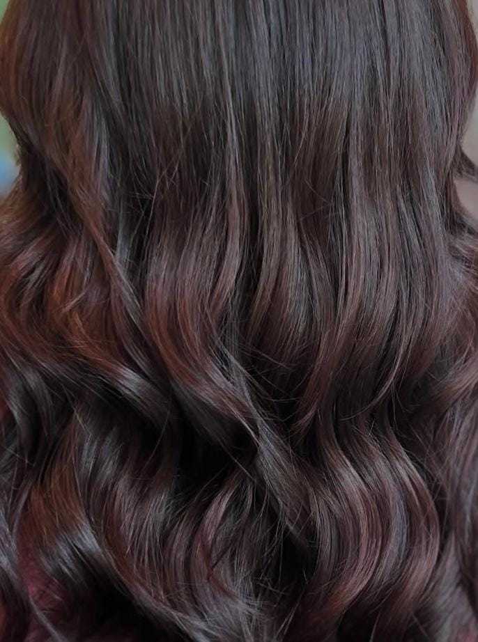 Wavy brown hair with soft curls cascading down.